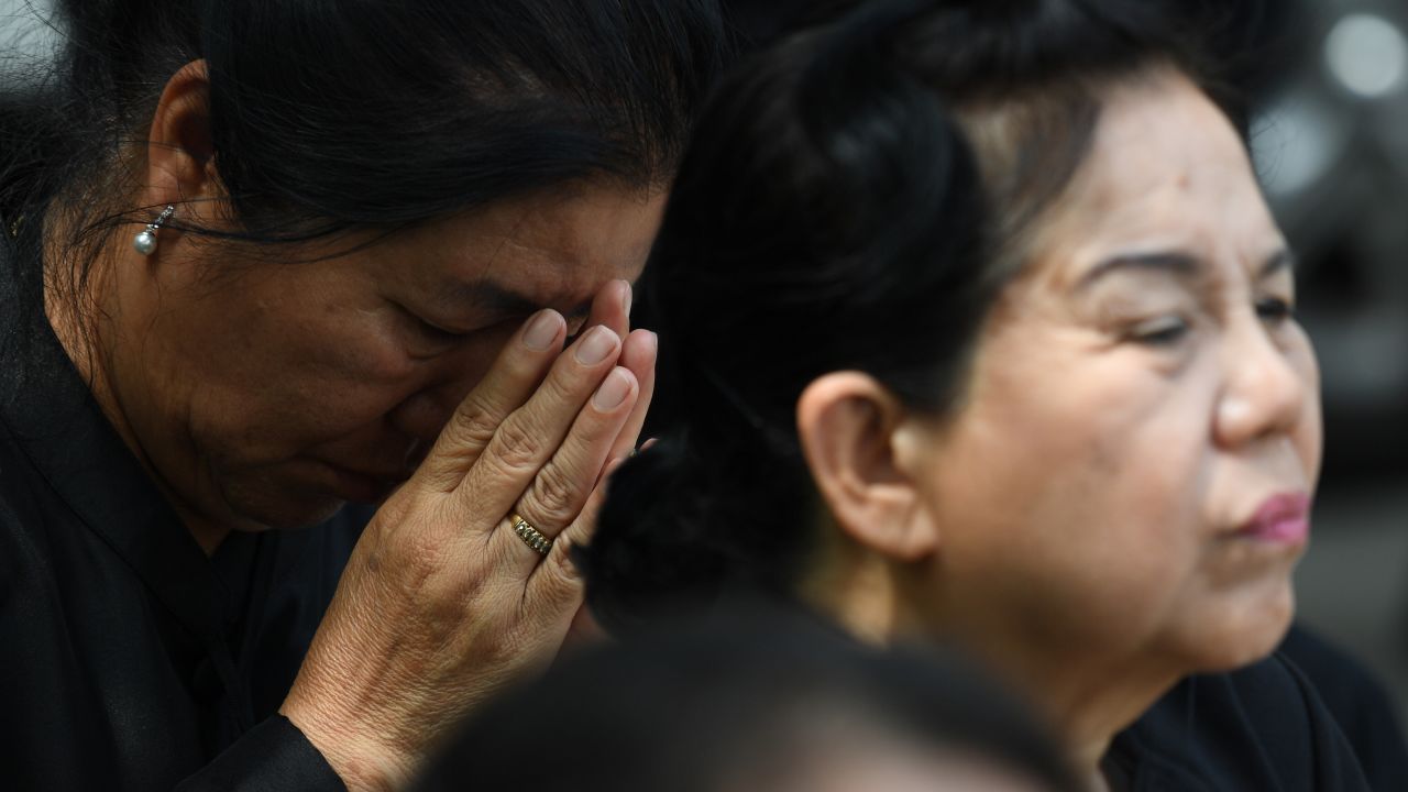 Mourners react during the funeral.