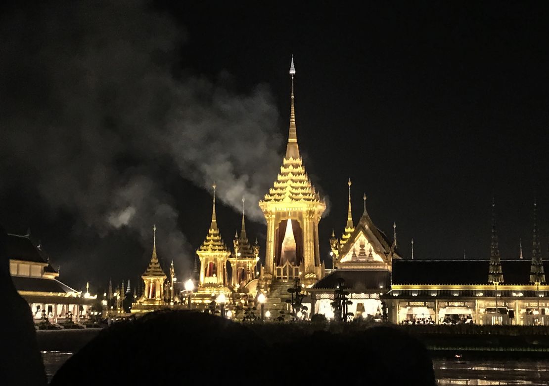 Smoke rises from the main pavilion of the cremation site where the body of late Thai King Bhumibol Adelyadej was being cremated late on October 26, 2017 in Bangkok. 
