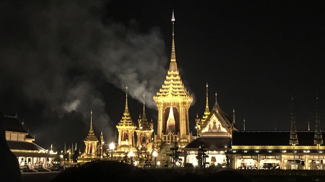 Smoke rises from the main pavilion of the cremation site where the body of late Thai King Bhumibol Adelyadej was being cremated late on October 26, 2017 in Bangkok.