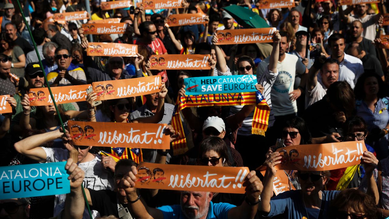 Protesters holds banners that read ''freedom'' in Catalan and include portraits of Jordi Sanchez and Jordi Cuixart, the imprisoned leaders of two Catalan grassroots organizations, during a rally outside the Catalan Parliament in Barcelona.
