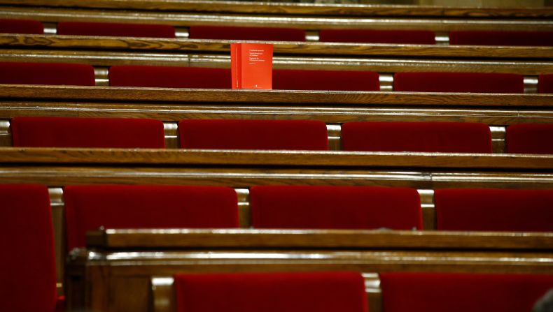 A book of the Spanish Constitution is placed on the benches of opposition Catalan lawmakers who left the chamber to boycott a vote on independence inside the Catalan parliament. Catalonia's regional government passed a motion saying they are establishing an independent Catalan Republic.