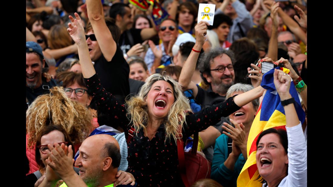 Maria Salut, 50, center, celebrates the unilateral declaration of independence of Catalonia outside the Catalan Parliament, in Barcelona, Spain.