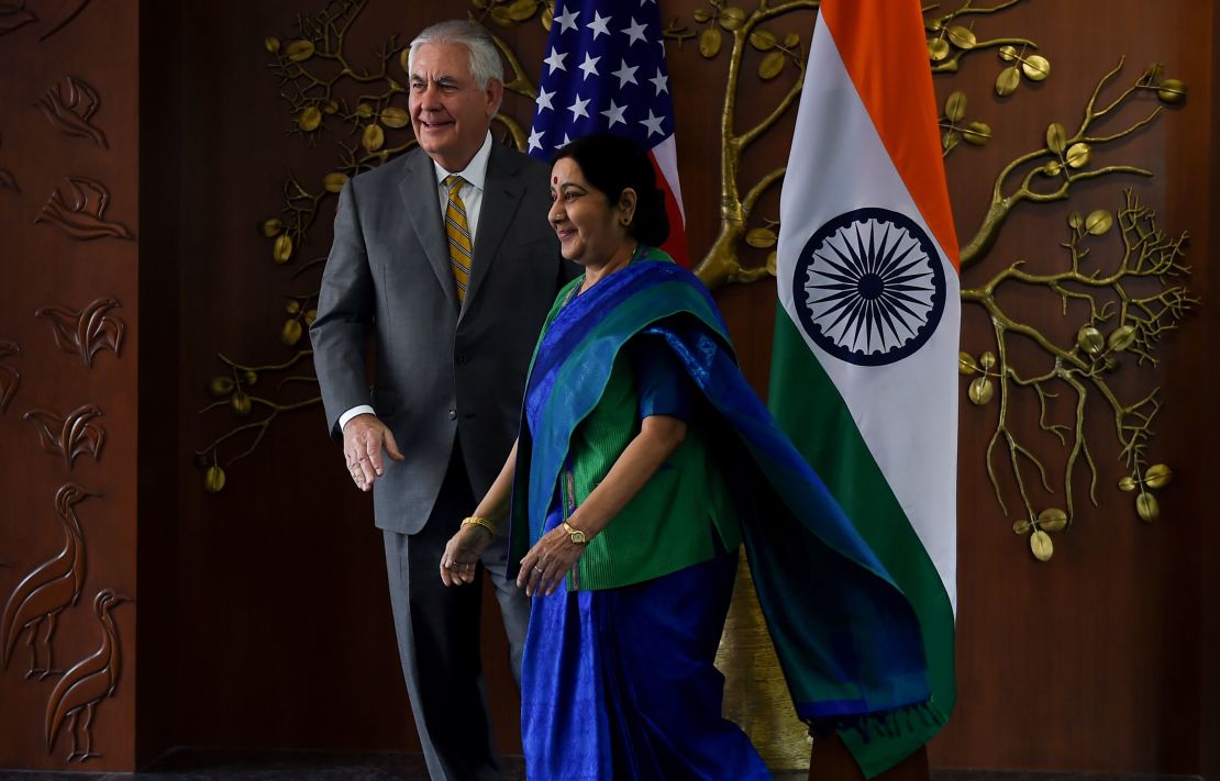 Indian Foreign Minister Sushma Swaraj and US Secretary of State Rex Tillerson walk together before their meeting in New Delhi.