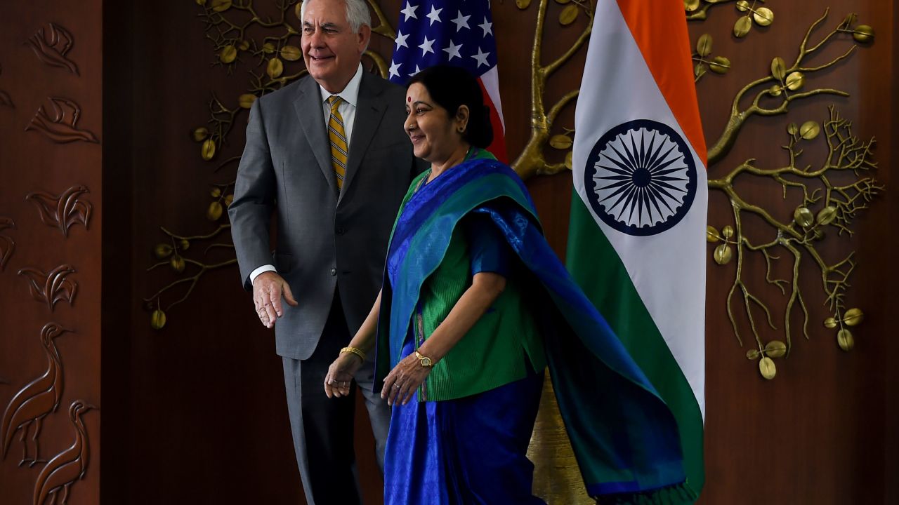 Indian Foreign Minister Sushma Swaraj and US Secretary of State Rex Tillerson walk together before their meeting in New Delhi.