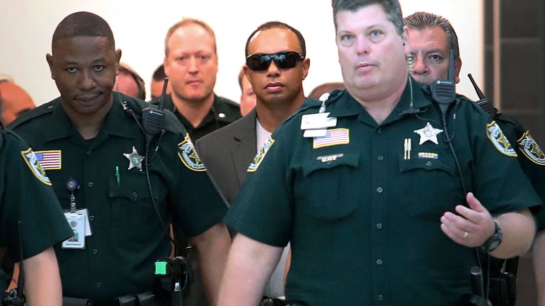Golfer Tiger Woods, center right,  makes his way into a North County Courthouse courtroom in Palm Beach Gardens, Florida on Friday Oct. 27, 2017.