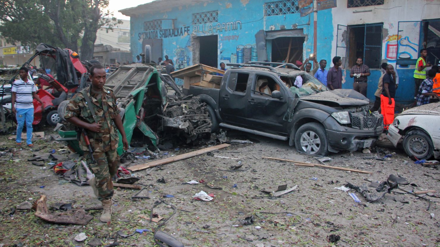 A Somali soldier is shown near wreckage from a car bomb detonated in Mogadishu, Somalia, on Saturday. 