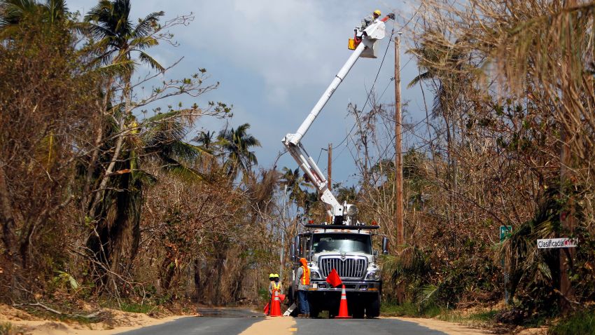 Puerto Rico Power Authority workers repair power lines in the aftermath of Hurricane Maria, in Loiza, Puerto Rico, September 28, 2017.
The US island territory, working without electricity, is struggling to dig out and clean up from its disastrous brush with the hurricane, blamed for at least 33 deaths across the Caribbean. / AFP PHOTO / Ricardo ARDUENGO        (Photo credit should read RICARDO ARDUENGO/AFP/Getty Images)