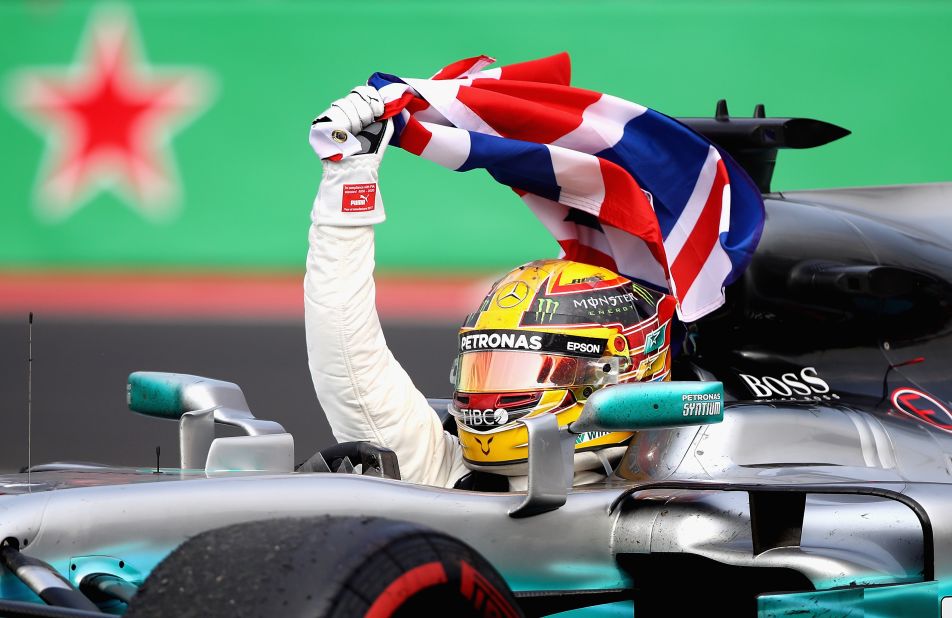 Lewis Hamilton celebrates at the Mexican Grand Prix after winning a fourth F1 drivers' title. 
