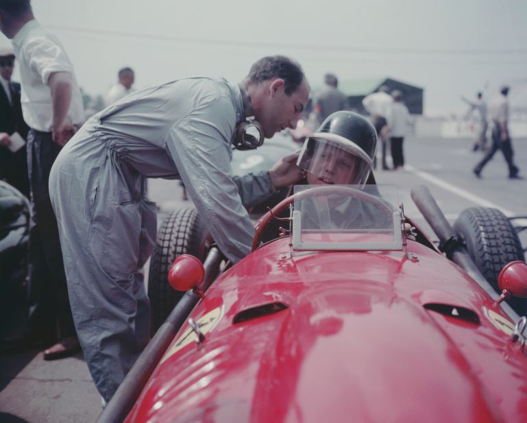 British racing driver Stirling Moss (left) adjusts Hawthorn's helmet before a race. The documentary contains many gruesome moments, but also many previously unseen clips of drivers off the track -- in the pit lane, horsing about and on the road as they made their way from one race to the next. <br />