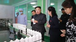 This undated picture released from North Korea's official Korean Central News Agency (KCNA) on October 29, 2017 shows North Korean leader Kim Jong-Un (C) inspecting the Pyongyang Cosmetics Factory, as his wife Ri Sol-Ju (R) looks on. / AFP PHOTO / KCNA VIA KNS / STR / South Korea OUT / REPUBLIC OF KOREA OUT   ---EDITORS NOTE--- RESTRICTED TO EDITORIAL USE - MANDATORY CREDIT 