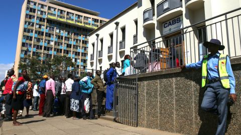 Zimbabweans queue to withdraw cash outside a bank in Harare. A severe currency shortage has led to growing interest in digital alternatives. 