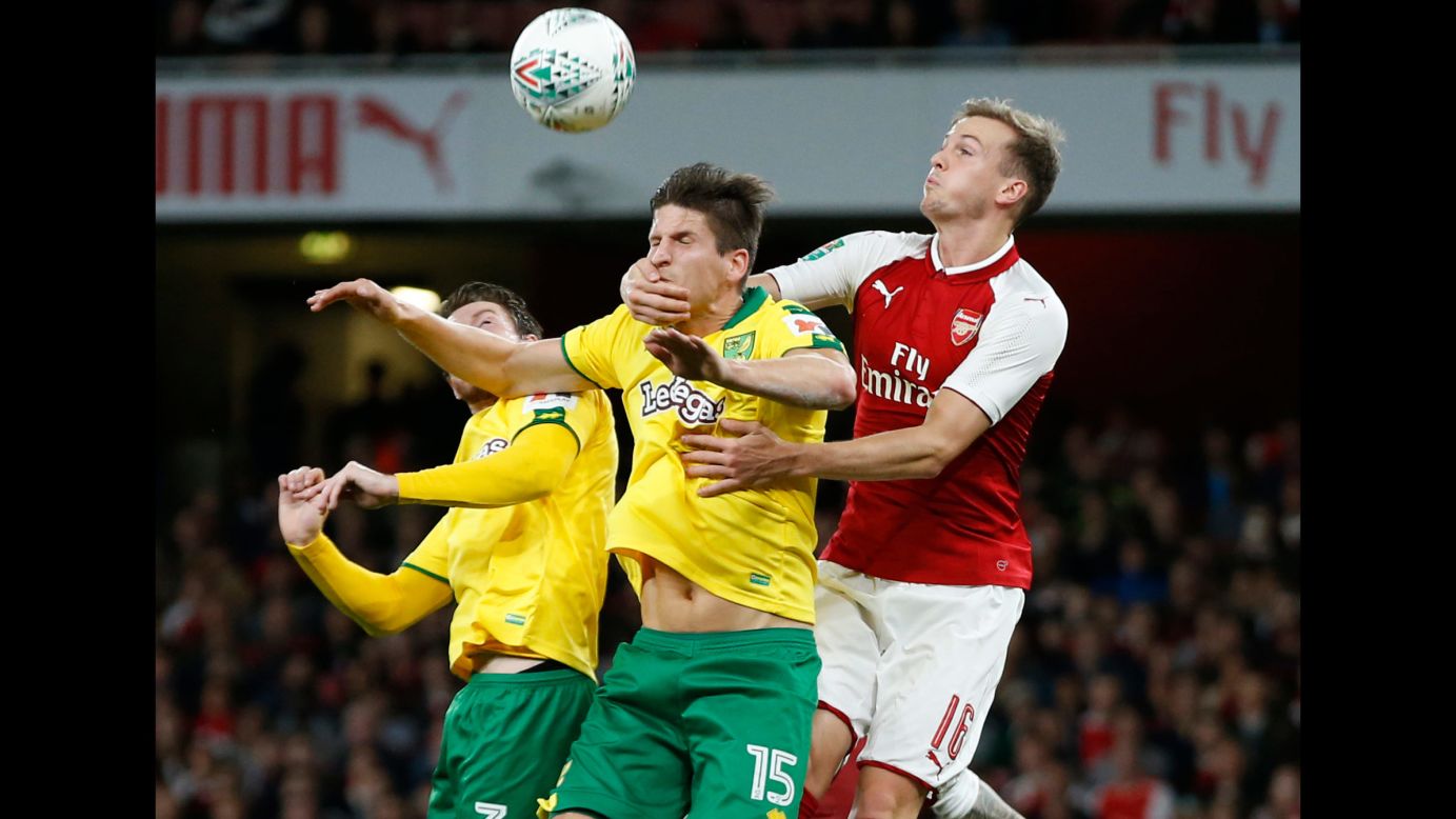 Arsenal's Rob Holding grabs the face of Norwich City's Timm Klose during a League Cup soccer match in London on Tuesday, October 24. Arsenal advanced to the quarterfinals with a 2-1 victory.