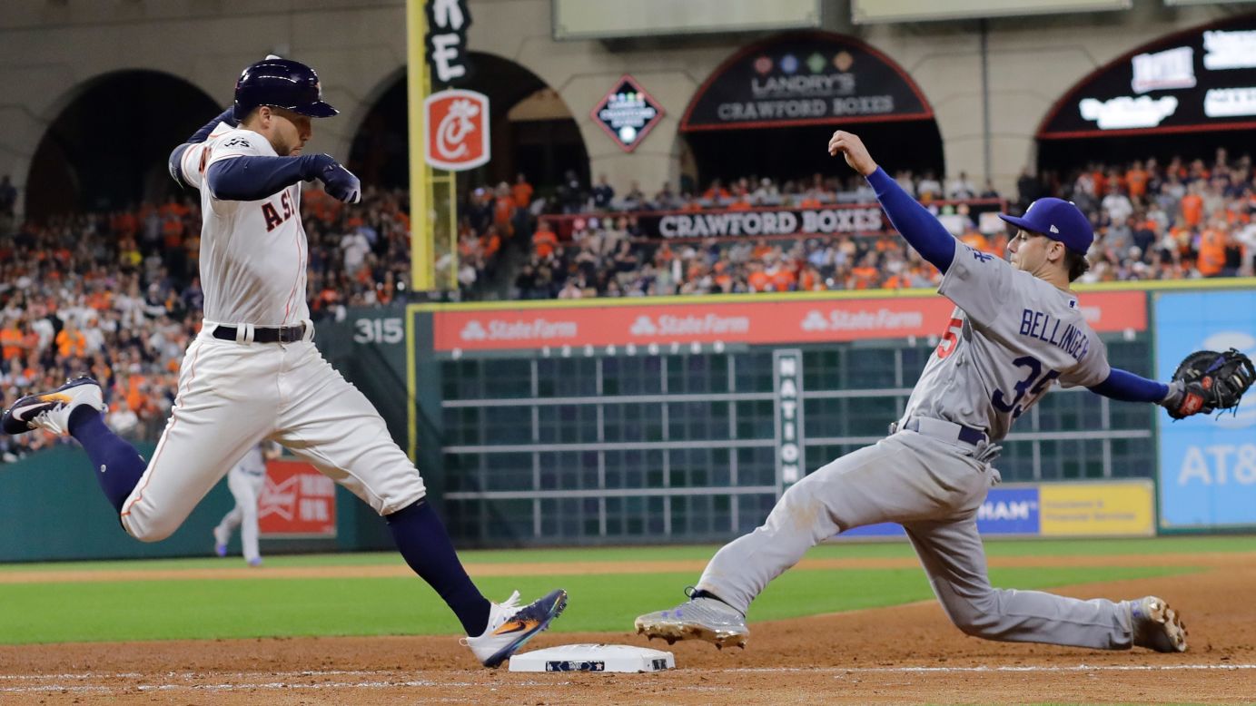 Houston's George Springer, left, beats Cody Bellinger to first base during Game 3 of the World Series on Friday, October 27.