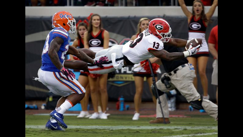 Georgia running back Elijah Holyfield dives over the goal line during the Bulldogs' 42-7 victory over Florida on Saturday, October 28. Holyfield is the son of former heavyweight boxing champion Evander Holyfield.