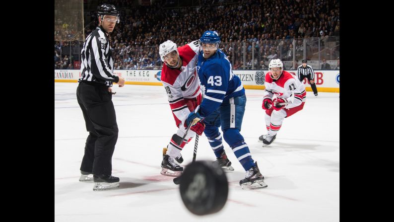 Carolina's Josh Jooris, left, and Toronto's Nazem Kadri look at the puck after a faceoff in Toronto on Thursday, October 26.