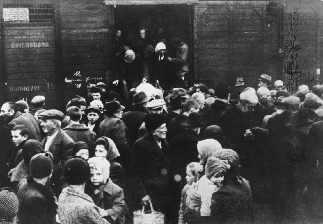 Jews deported from Hungary exit a German boxcar onto a crowded railway platform at  Auschwitz concentration camp, Poland, in May 1944.