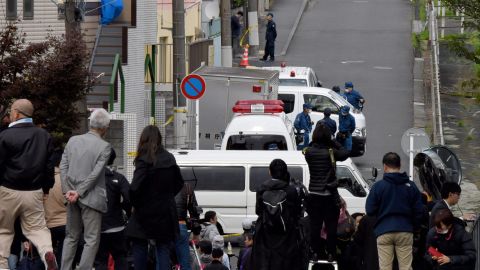 Media gather in front of an apartment (partialy covered with a blue sheet) where Japanese police found body parts in a suburb of Tokyo.