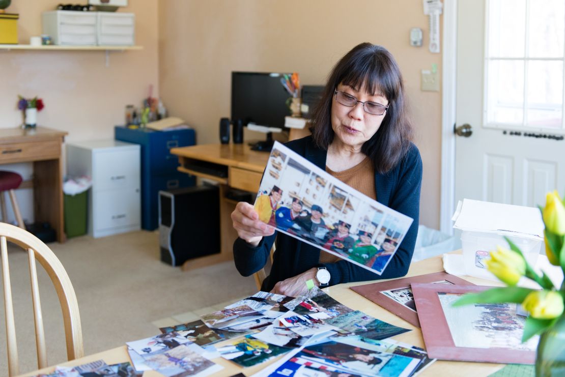 Patricia Martin looks through old photographs of her husband, Robert Martin, who died in 2014.