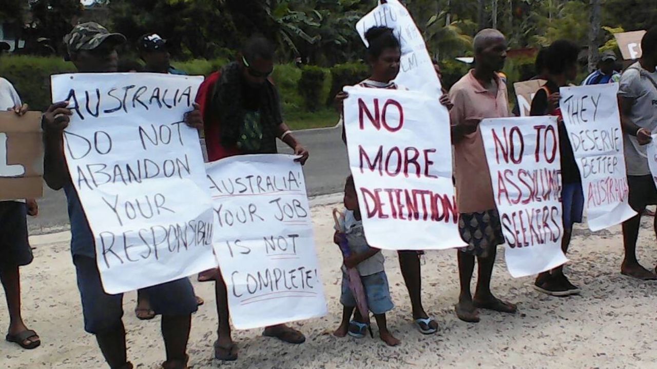 Manus Island locals hold signs at a protest calling for the refugees to be resettled elsewhere, on Tuesday, October 31.