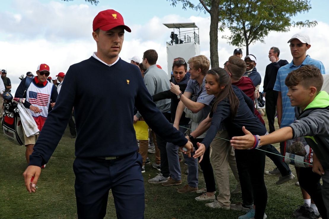 Fans cheer as Jordan Spieth of the United States high-fives them during the Presidents Cup at Liberty National Golf Club.