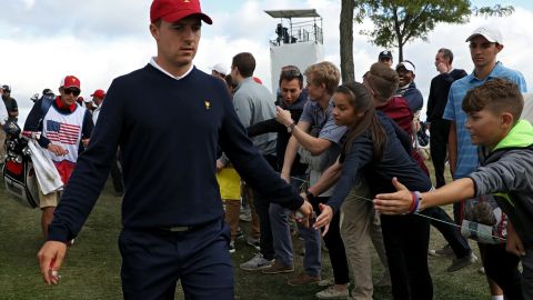 Fans cheer as Jordan Spieth of the United States high-fives them during the Presidents Cup at Liberty National Golf Club.