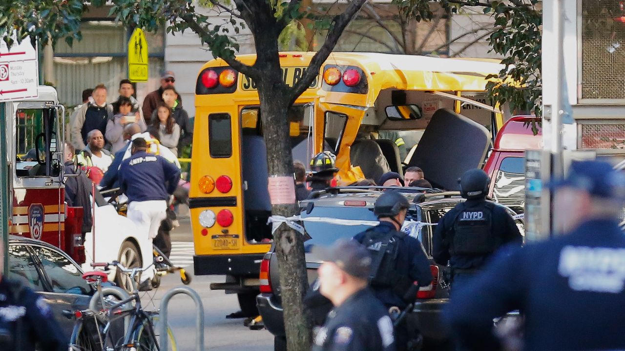 Authorities respond near a damaged school bus Tuesday, Oct. 31, 2017, in New York. A motorist drove onto a busy bicycle path near the World Trade Center memorial and struck several people on Tuesday police and witnesses said. (AP Photo/Bebeto Matthews)