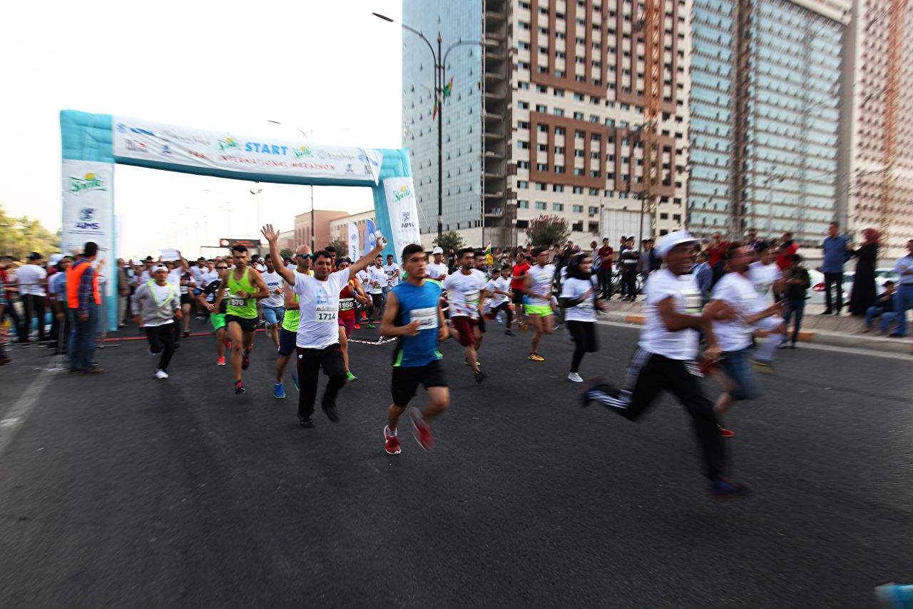 Despite the disruption, 2,000 people still participated. Here, runners stream onto the course after the starting buzzer.