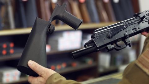A bump stock device, seen here at left, fits on a semi-automatic rifle to increase its firing speed.