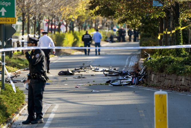 Bicycles and debris are scattered on the bike path.