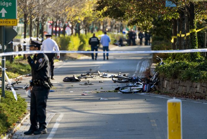 Bicycles and debris are scattered on the bike path.