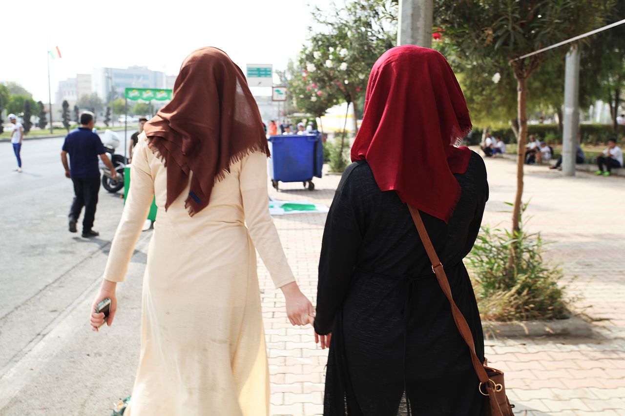 Two local female participants wearing the hijab run hand in hand at the race.