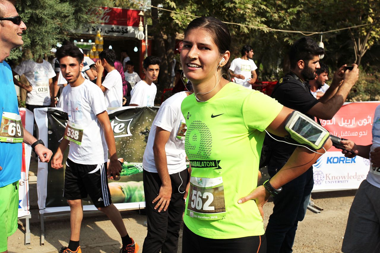 A German runner who reached Erbil for the race catches her breath at the end of the course.