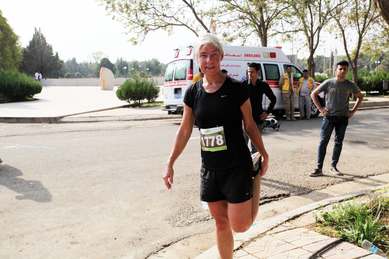 An expat runner stretches at the end of the marathon. After the race, there was a winners' awards ceremony and martial arts performances.
