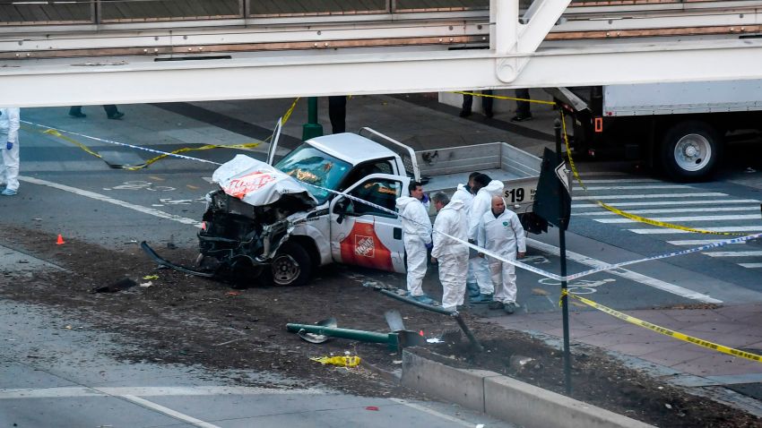 Investigators inspect a truck following a shooting incident in New York on October 31, 2017. 
Several people were killed and numerous others injured in New York on Tuesday when a suspect plowed a vehicle into a bike and pedestrian path in Lower Manhattan, and struck another vehicle on Halloween, police said. A suspect exited the vehicle holding up fake guns, before being shot by police and taken into custody, officers said. The motive was not immediately apparent.

 / AFP PHOTO / Don EMMERT        (Photo credit should read DON EMMERT/AFP/Getty Images)