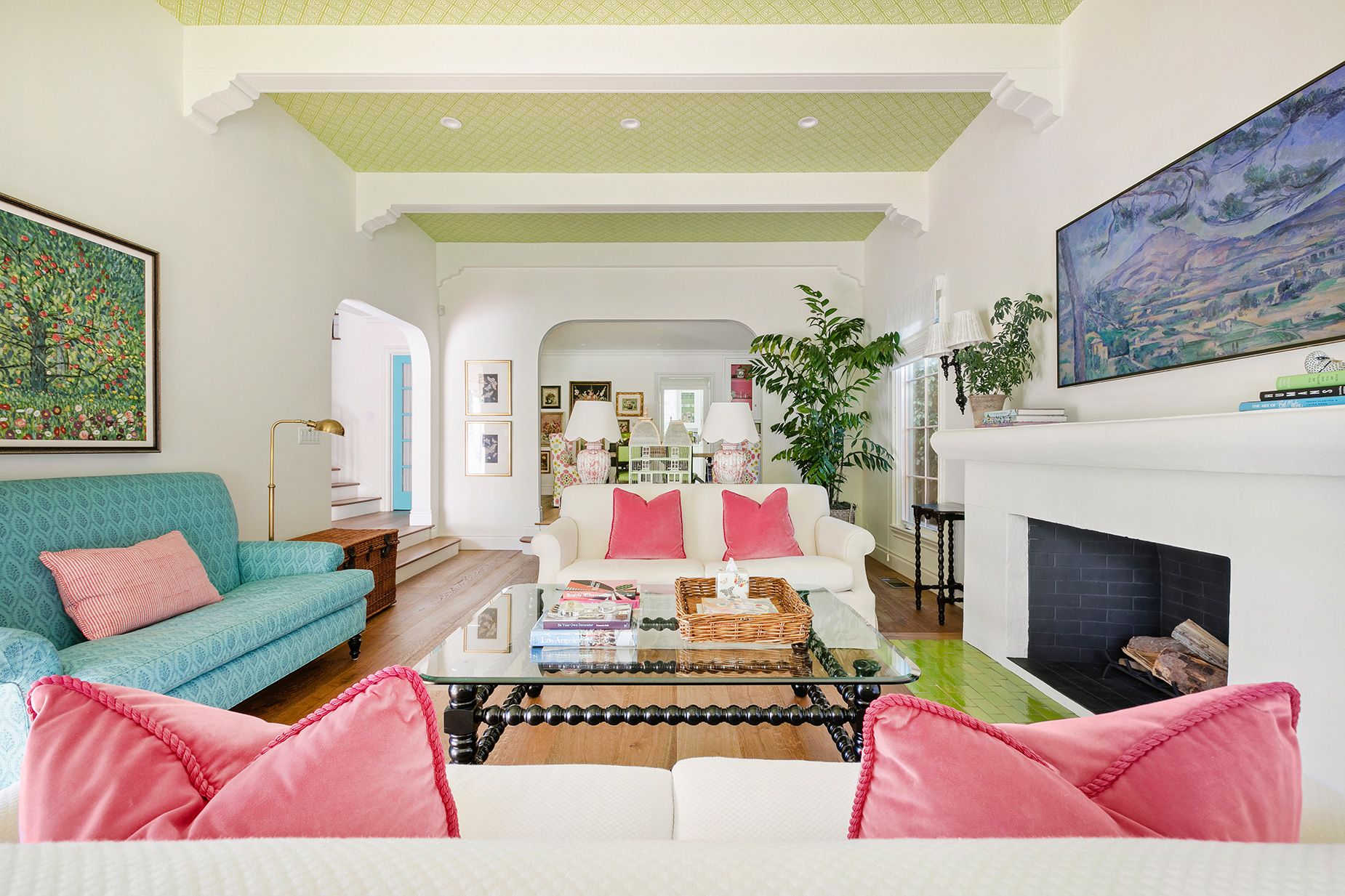 The living room includes original beamed ceilings and a wood-burning fireplace.