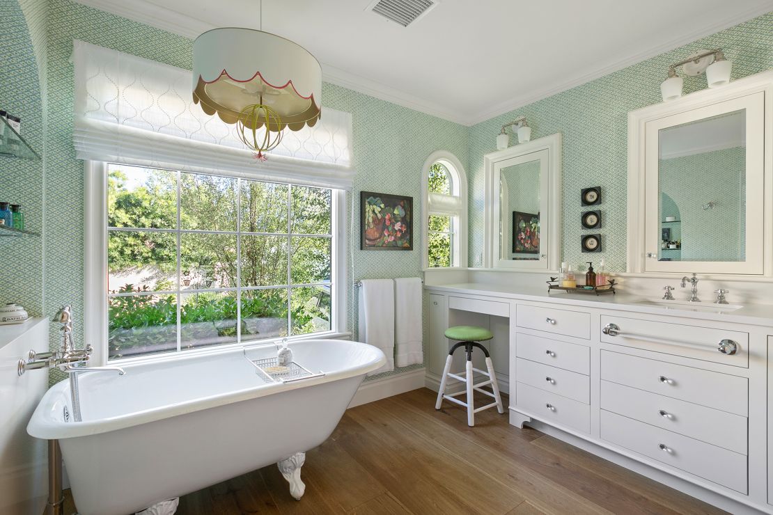The bathroom, with a claw foot tub, is full of charm and sunlight.