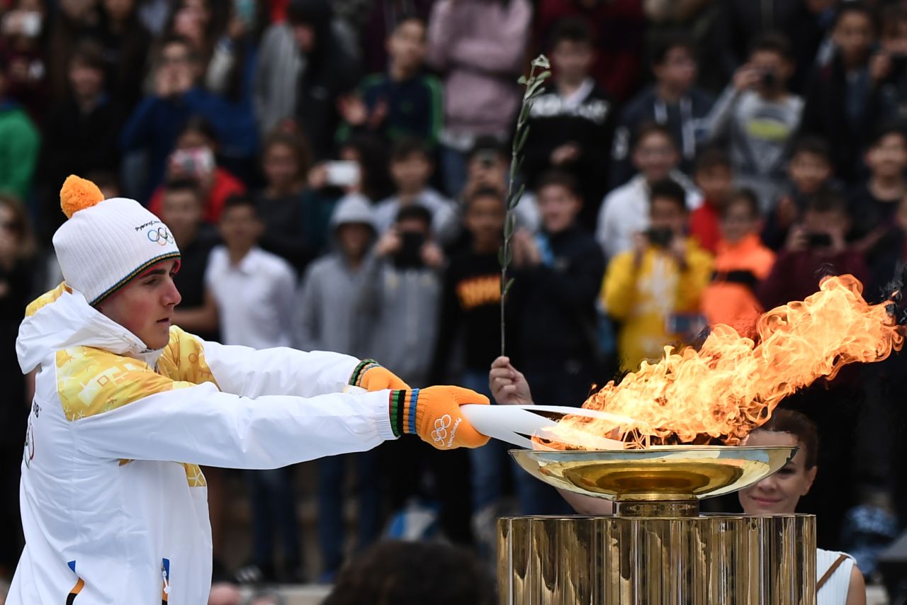 After completing a week-long tour of Greece, the flame was officially passed to the PyeongChang organizing committee at a handover ceremony. Greek Alpine skier Ioannis Proios is shown holding the torch at the ceremony in Athens' Panathenaic Stadium on October 31, 2017. 