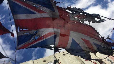 A tattered Union Jack flutters outside Banksy's Walled Off Hotel, the site of the artist's latest installation. 