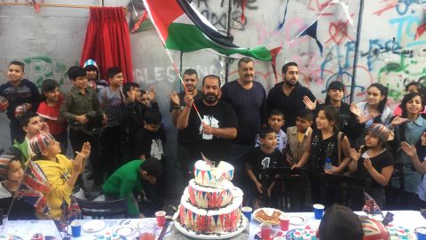 Children from neighboring refugee camps were invited to Banksy's "jubilee street party" in Bethlehem. 