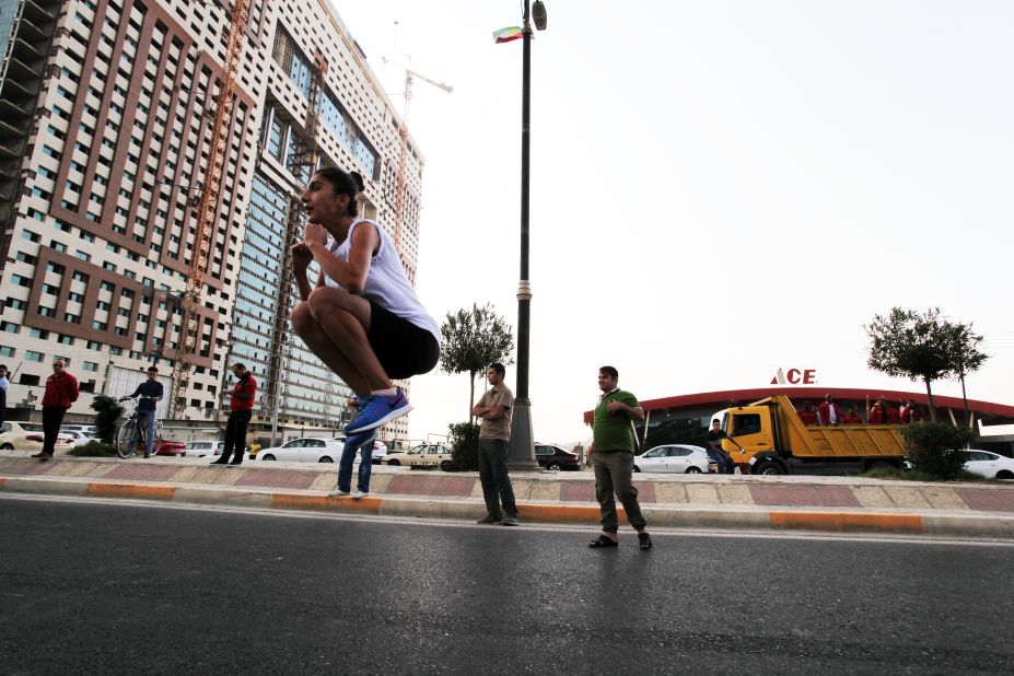A professional Kurdish runner warms up at the start line. Some Iraqis who had made it to Erbil to run the full race were disappointed it was canceled, but organizers said they hoped to bring reinstate the 42km race next year.