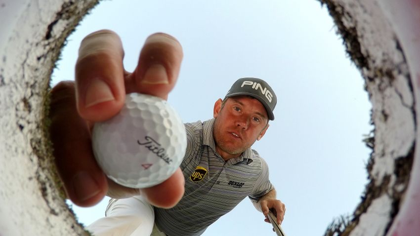 DUBAI, UNITED ARAB EMIRATES - JANUARY 27:  Lee Westwood of England takes a ball out of a golf hole on the putting green during a practice round prior to the Omega Dubai Desert Classic at the Emirates Golf Club on January 27, 2015 in Dubai, United Arab Emirates.  (Photo by Ross Kinnaird/Getty Images)