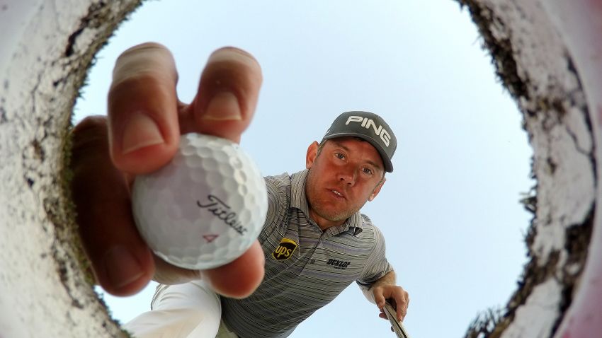DUBAI, UNITED ARAB EMIRATES - JANUARY 27: Lee Westwood of England takes a ball out of a golf hole on the putting green during a practice round prior to the Omega Dubai Desert Classic at the Emirates Golf Club on January 27, 2015 in Dubai, United Arab Emirates. (Photo by Ross Kinnaird/Getty Images)