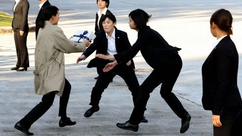 Female police officers wearing suits take part in a training on November 1 in Tokyo.