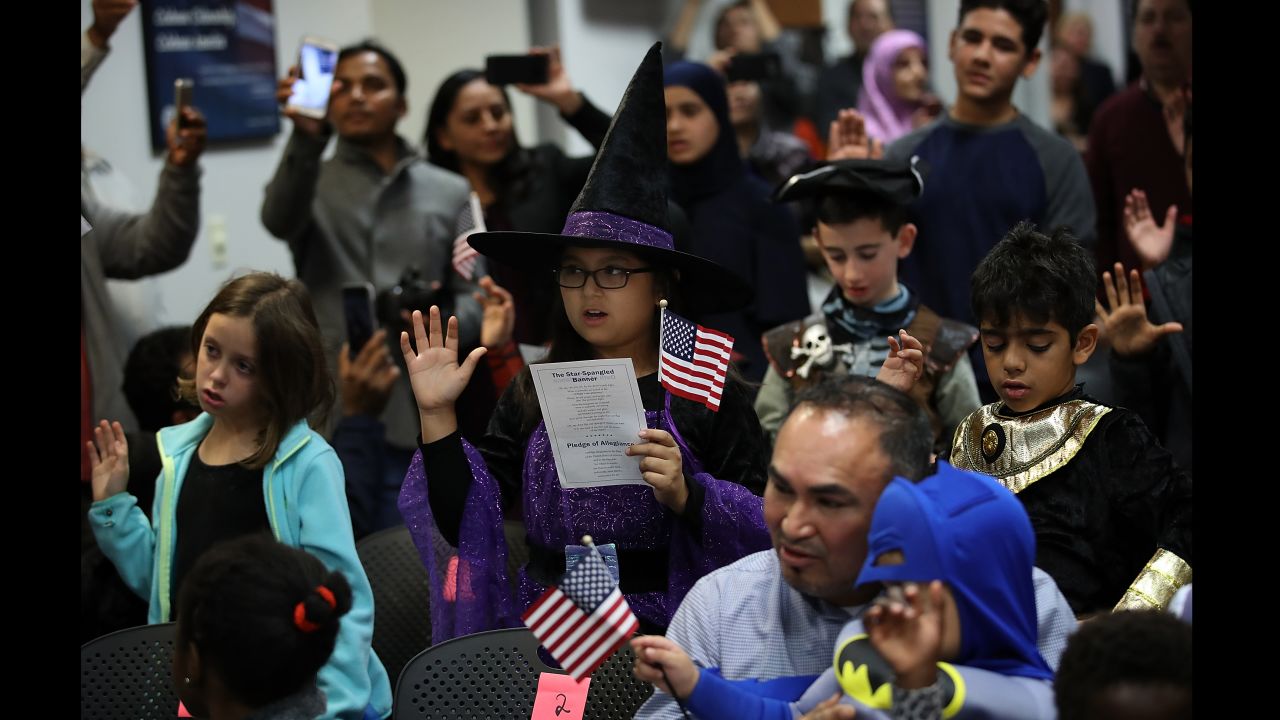 Children from 22 countries take the oath of US citizenship during a Halloween-themed ceremony in Fairfax, Virginia, on Tuesday, October 31.