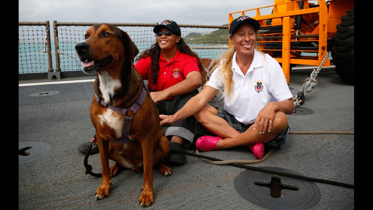 Jennifer Appel, right, and Tasha Fuiava sit with their dogs on the deck of the USS Ashland on Monday, October 30. The two women from Hawaii were rescued in the Pacific Ocean about 900 miles southeast of Japan. <a href="http://www.cnn.com/2017/10/31/asia/pacific-sailors-jennifer-appel-tasha-fuiava-questions/index.html" target="_blank">They said they had been stranded on a crippled sailboat</a> for more than five months.