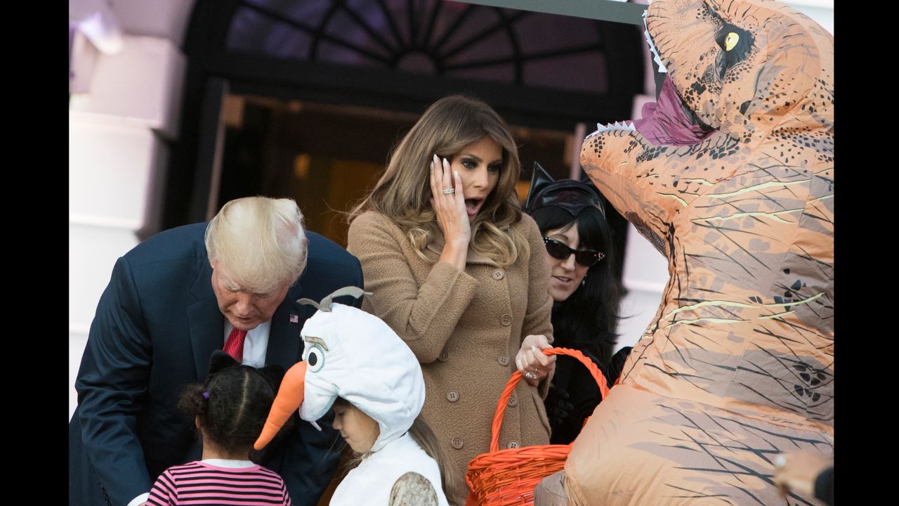US President Donald Trump and first lady Melania Trump hand out Halloween candy to children at the White House on Monday, October 30.