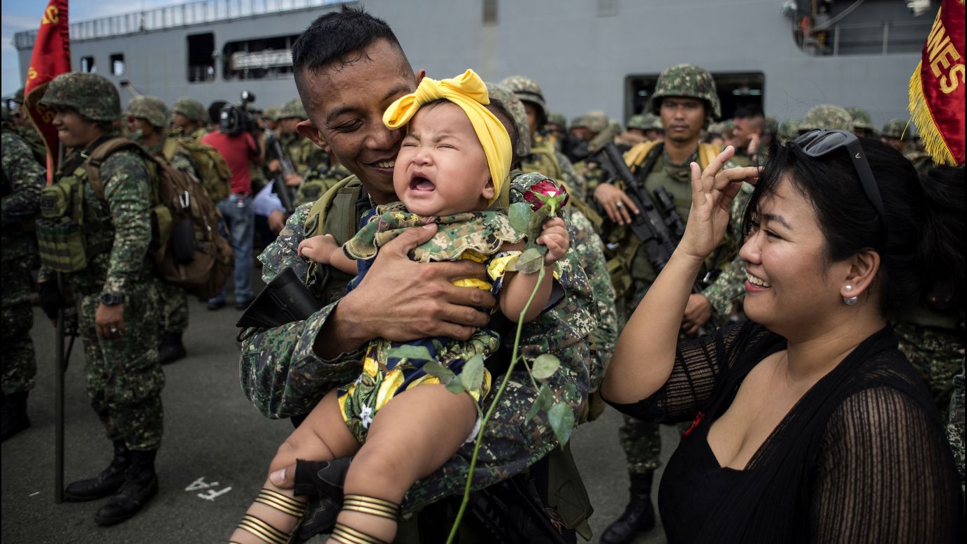 A Philippine soldier hugs his baby daughter after returning from a five-month deployment in the city of Marawi on Monday, October 30. President Rodrigo Duterte <a href="http://www.cnn.com/2017/10/17/asia/duterte-marawi-liberation/index.html" target="_blank">announced last month</a> that Marawi had been liberated from ISIS-affiliated militants.