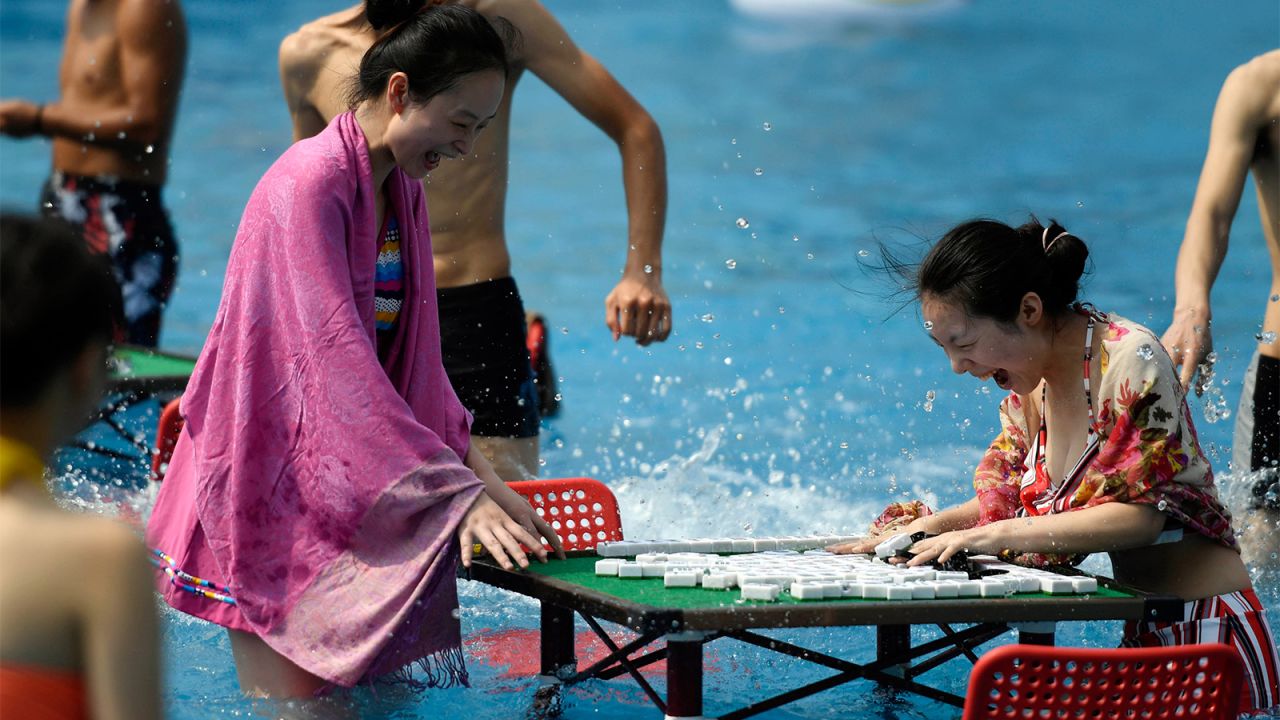 <strong>Pool gaming: </strong>Known as one of the top "furnace cities" in China -- cities with extremely hot summer weather --  Chongqing combats the heat by moving mahjong and Chinese chess tables to the pools.  