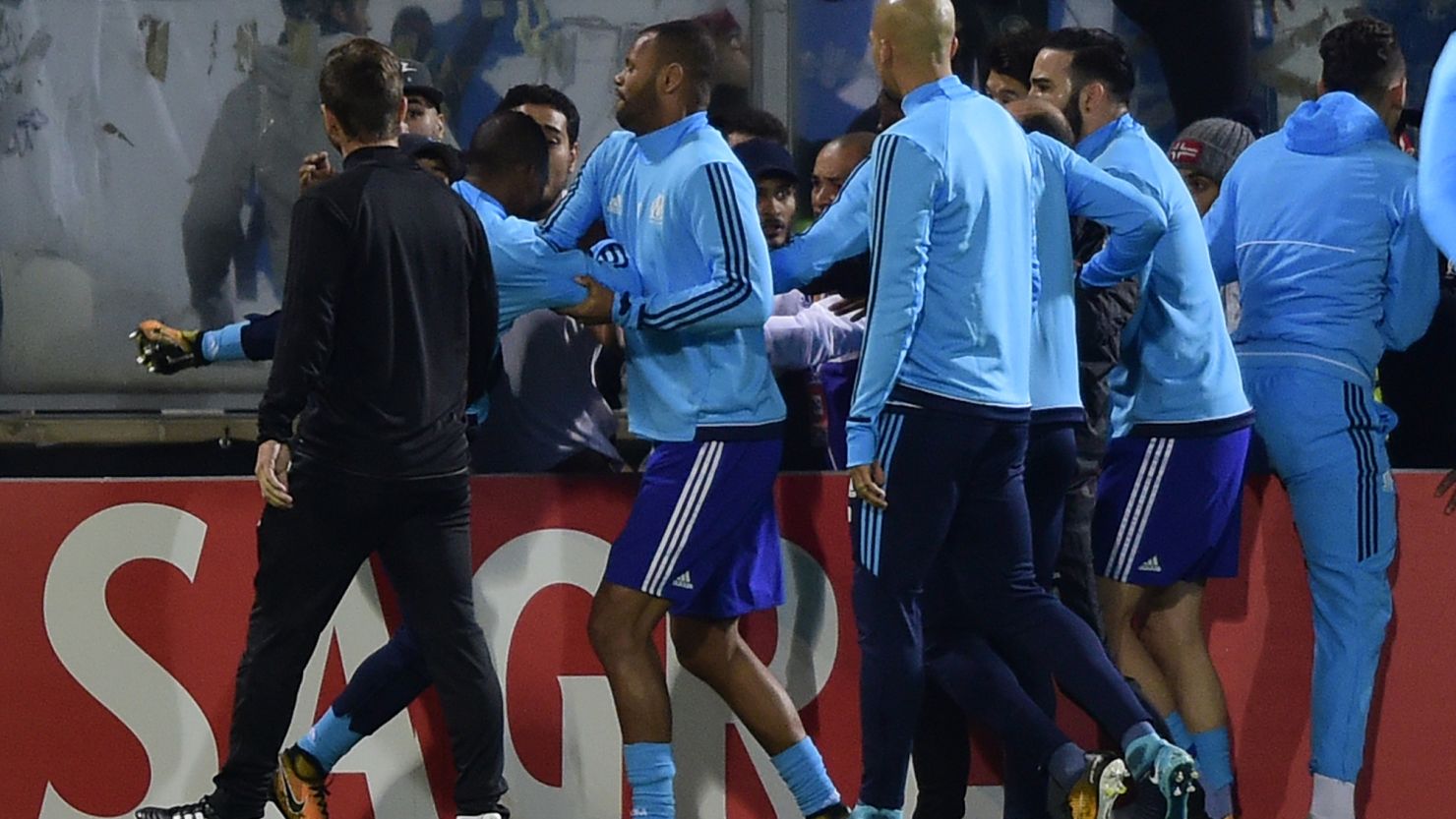 Teammates try to calm down Marseille's defender Patrice Evra.