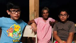 Members of the Rivera family sit in their powerless home in Manati, Puerto Rico.